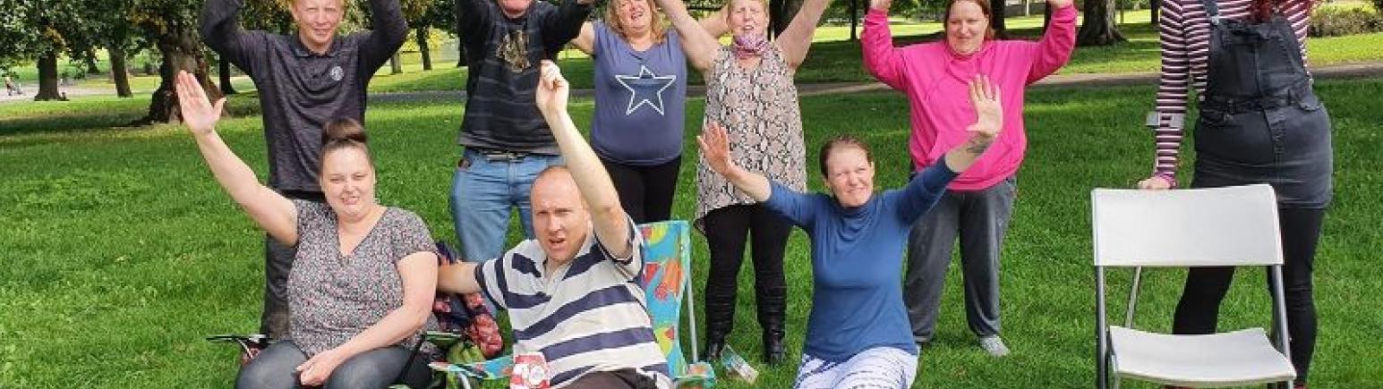 People in park waving at camera