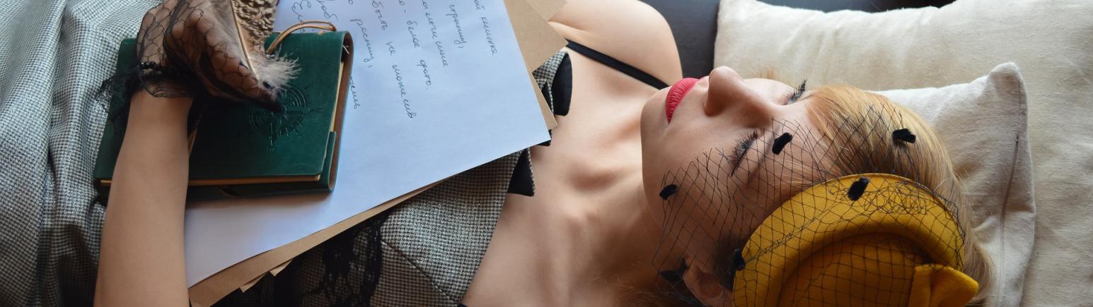 Women holding books while laying down
