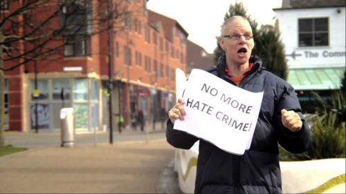 Man holding sign - No more hate crime!